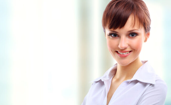 Positive business woman smiling over white background